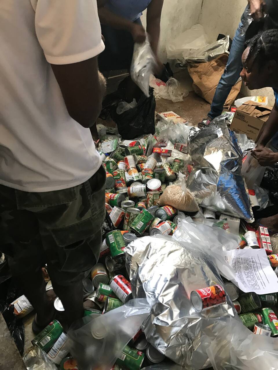 Canned goods and dry food being packed for relief