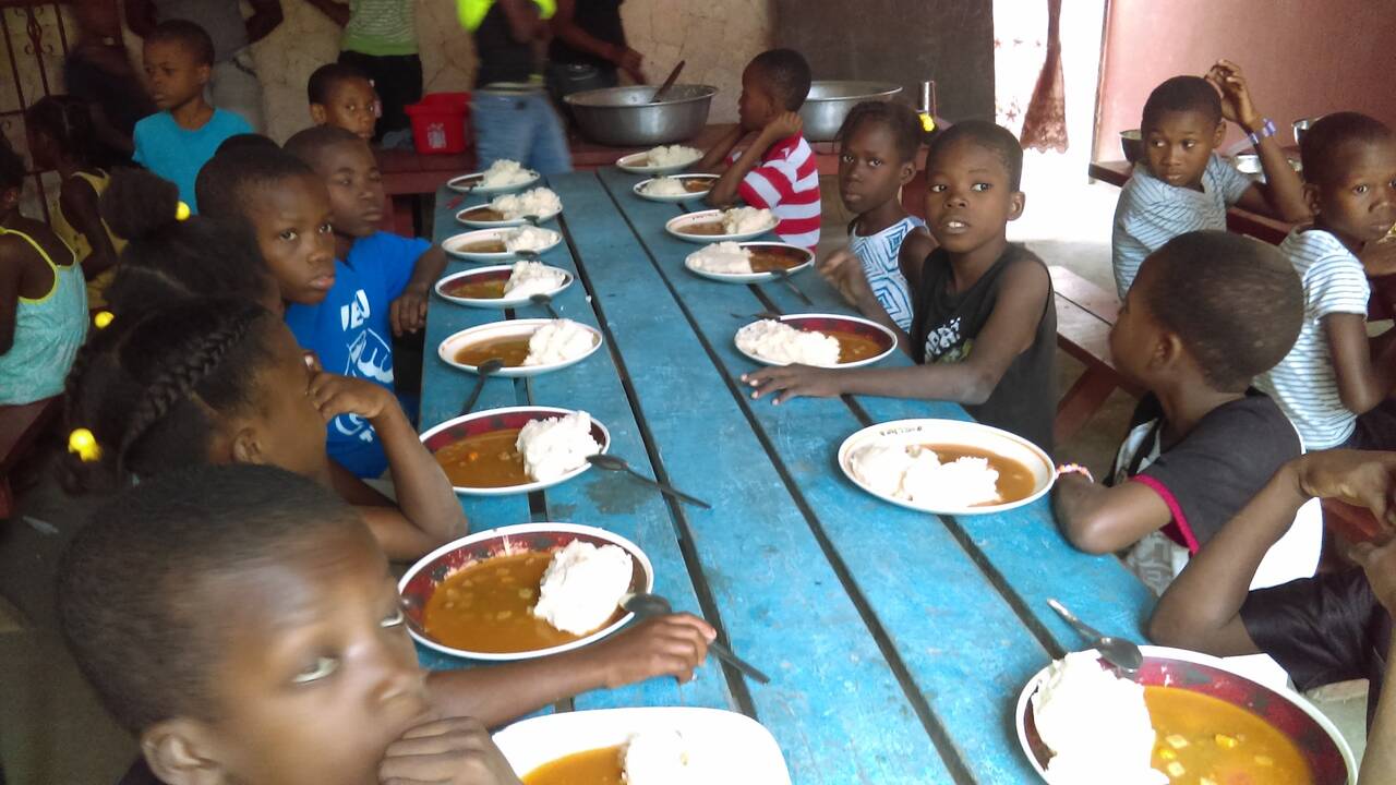 Children sharing a hot meal at the feeding program