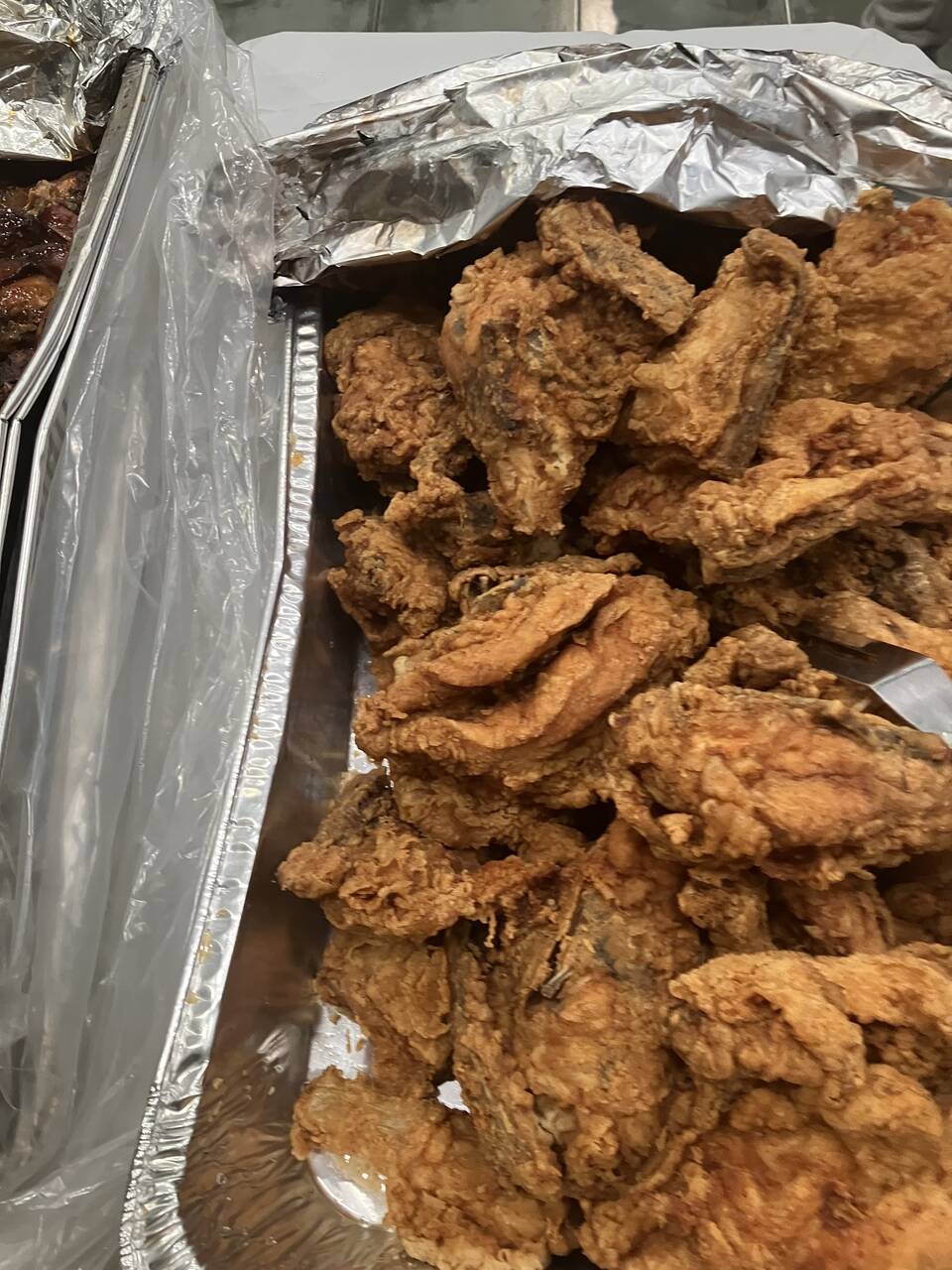Tray of golden fried chicken for shelter guests